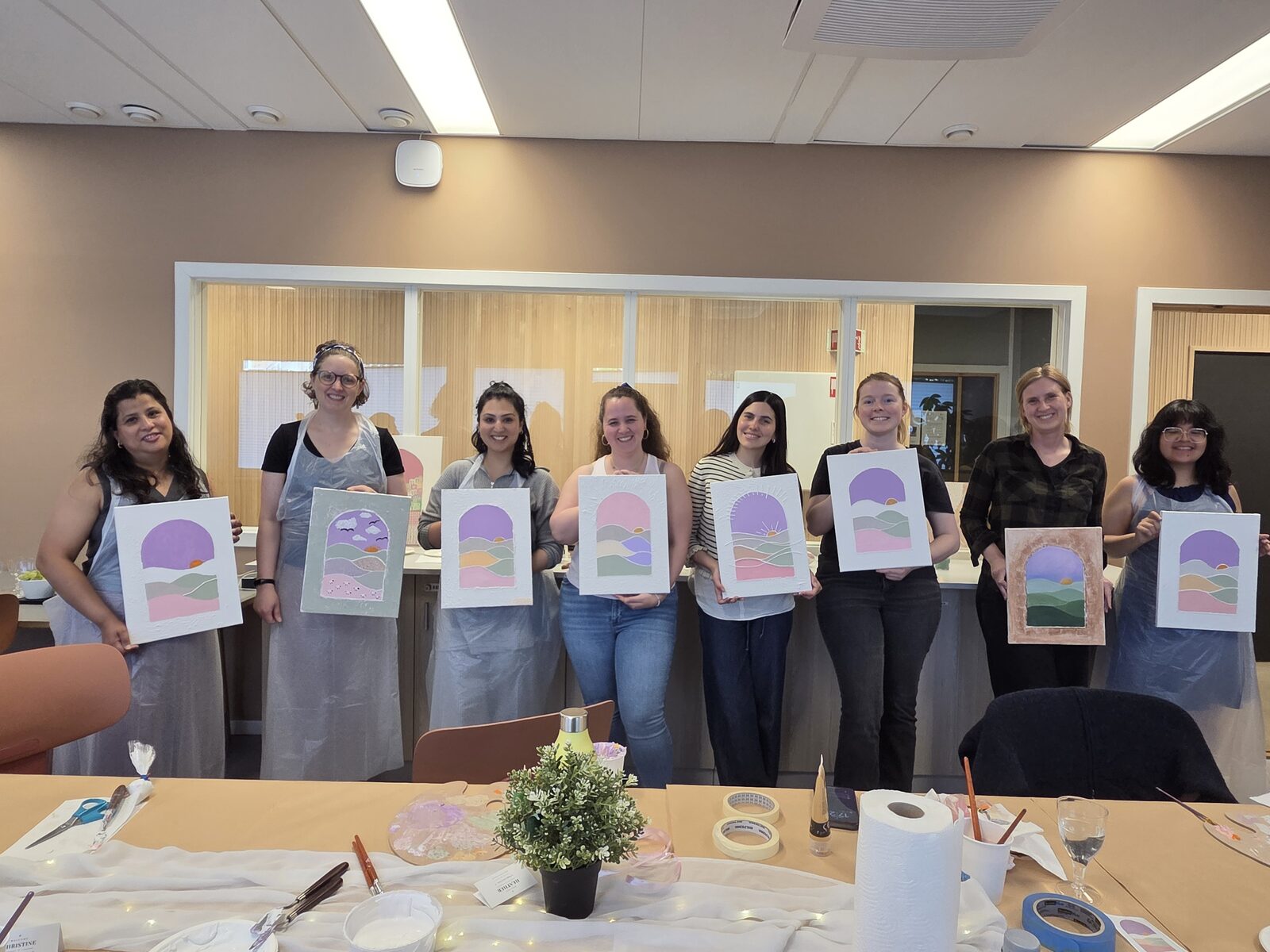 Guests holding their finished textured canvases