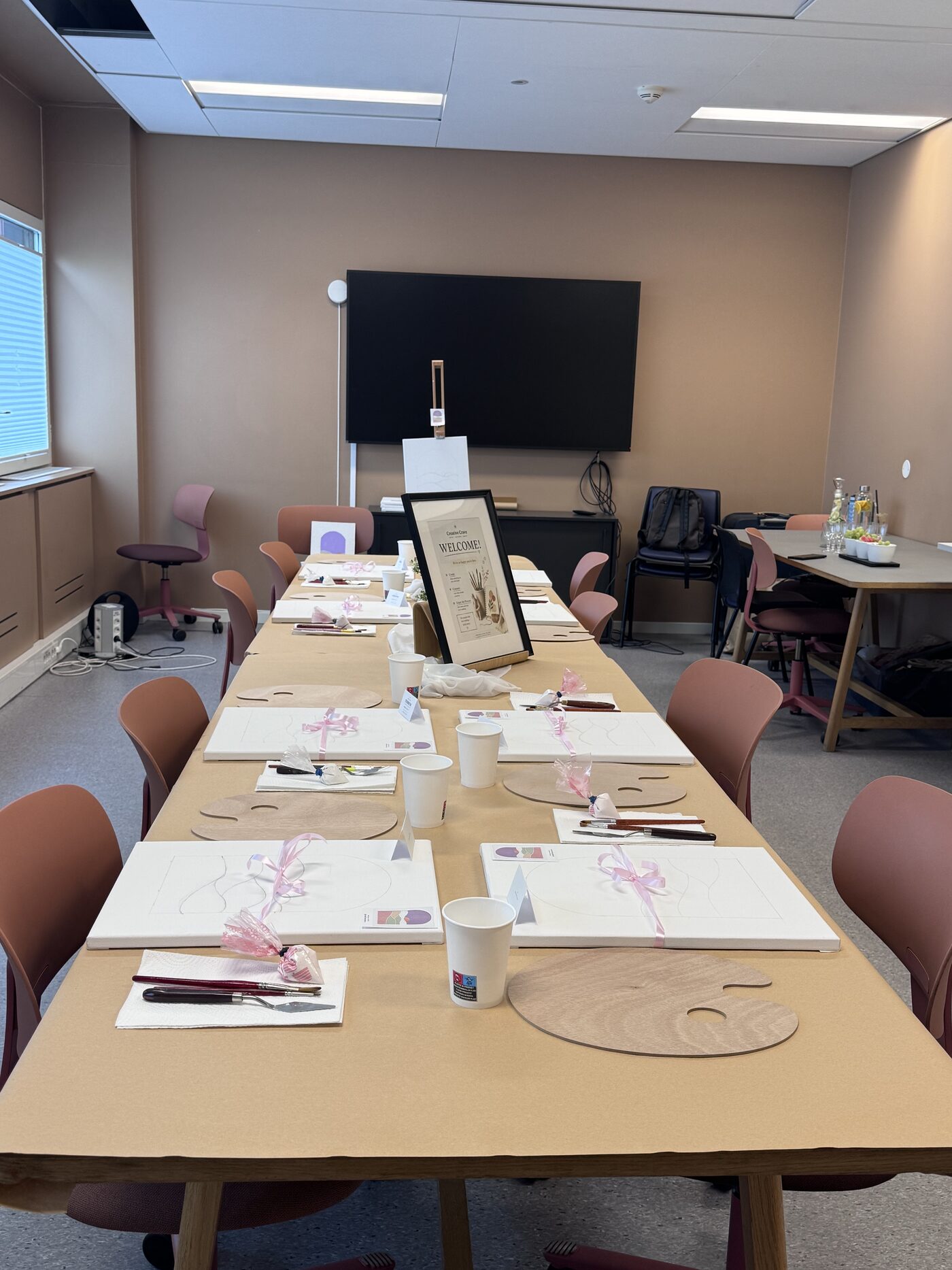 Workshop table set with canvases, palettes and brushes
